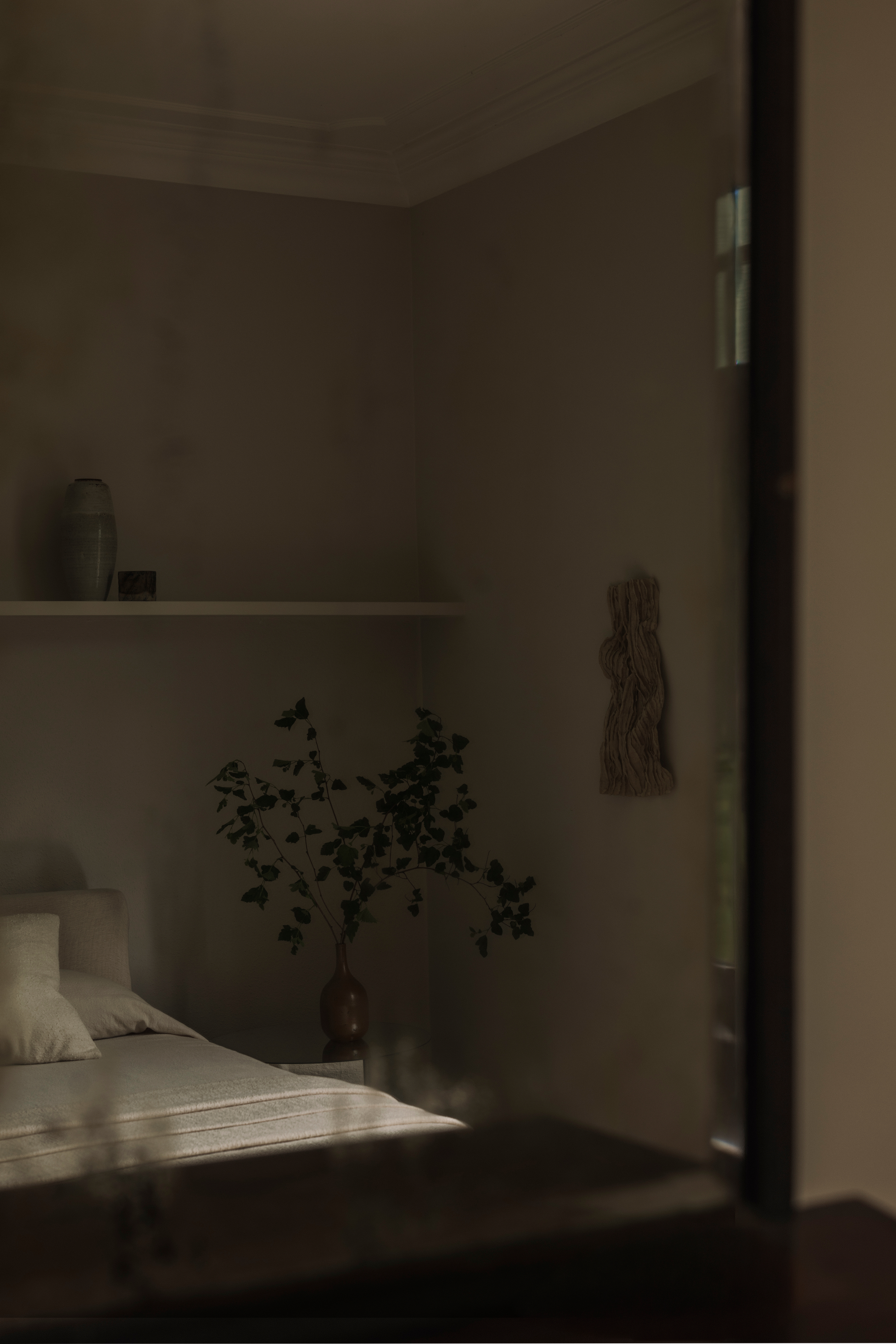 A quiet bedroom at Beech House, with an arched opening toward the garden.